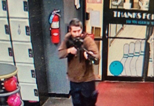 In this image taken from video released by the Androscoggin County Sheriff's Office, an unidentified shooter points a gun while entering Sparetime Recreation in Lewiston, Maine, on Wednesday, Oct. 25, 2023. Maine State Police ordered residents in the state's second-largest city to shelter in place Wednesday night as the suspect remains at large. (Androscoggin County Sheriff's Office via AP)