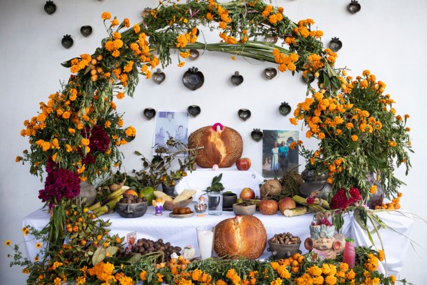 A Day of the Dead altar stands on the terrace at Ana Martínez's home in Santa Maria Atzompa, Mexico, Tuesday, Oct. 31, 2023. Martínez and others in southern Mexico's Oaxaca state wait with anticipation for Day of the Dead celebrations every Nov. 1, when families place homemade altars to honor their dearly departed and spend the night at the cemetery, lighting candles in the hope of illuminating their paths. (AP Photo/Maria Alferez)