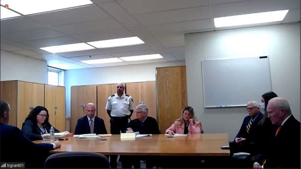 Judge William F. Sullivan, center, listens as Plymouth Assistant DA Jennifer Sprague speaks during the Superior Court arraignment of Lindsay Clancy, the Duxbury mother accused of killing her three kids, held via Zoom from Tewksbury Hospital on Thursday morning. Clancy's defense attorney Kevin Reddington listens from the far right of the screen. (Screengrab / Plymouth Superior Court)